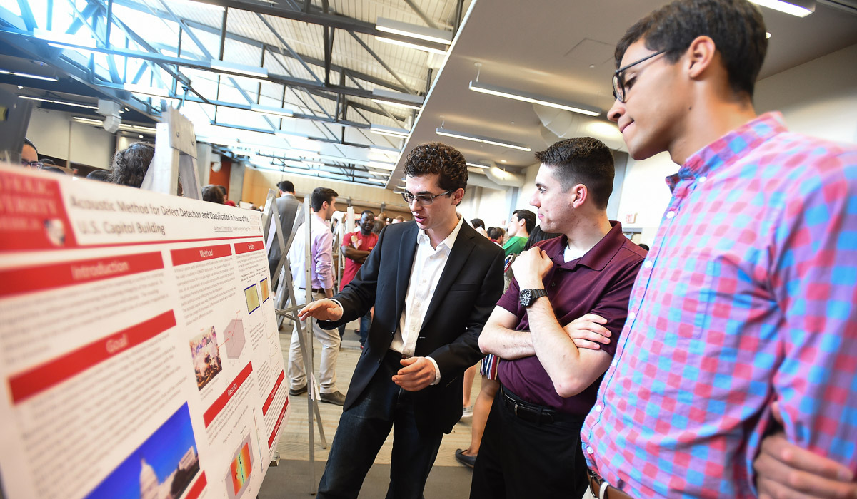 Students discussing a research poster